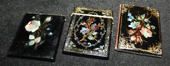 Three Victorian card cases with floral shell inlay heightened in gilt, one of wallet form and one lacking top